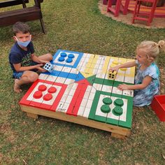 two young children playing with an outdoor game