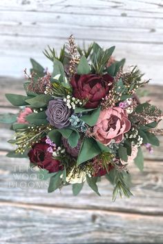 a bridal bouquet with purple and red flowers