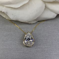 "The pendant pictured is a pear shaped simulated diamond #6884 -Approximate total carat weight: approx. 4.00ctw diamond equivalent -Center Stone Size: 13x9mm - approx. 4.00ct diamond equivalent -Center Stone Shape: pear -Gem Type: simulated diamond -Stone Clarity: VVS1 -Stone Color: D -Moh's Scale: 8.5 hardness -Metal Type and Purity: 14k yellow gold (also shown in 14k white gold) -Setting: bezel set -Chain: delicate 14k gold chain / heavier option with lobster claw available (use dropdown to se Luxury Timeless Solitaire Teardrop Pendant Necklace, Luxury Teardrop Solitaire Necklace With Prong Setting, Luxury Teardrop Solitaire Necklace In Prong Setting, Luxury Teardrop Pendant Necklace With Prong Setting, Luxury Timeless Teardrop Solitaire Necklace, Affordable Pear-shaped Jewelry Gift, Luxury Solitaire Necklace With Teardrop Pendant And Prong Setting, Luxury Classic Teardrop Pendant Jewelry, Luxury Gold Teardrop Solitaire Necklace