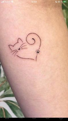 a small cat tattoo on the left side of the leg, which is black and white