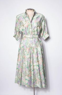 Vintage Cotton Summer Dress Women's Maxi Dress Belted Green Floral Pattern Sz 10 This is a beautiful spring floral cotton maxi dress. I think it is from the late 80s or early 90s. The fabric is 100% cotton, super breathable, and very comfortable to wear. Kinda pale pastel garden party vibes. Or maybe Steel Magnolia vibes. Made of a gorgeous printed cotton in greens, pinks, purple, and white. The front unbuttons down to the waist. This would be a great dress for a summer wedding or for some gorgeous picnics.  Excellent vintage condition. Light wear from age.  This dress has pockets! Includes a matching belt.  Tag size 10 Measurements  Chest 21" across or 42" doubled Waist 15" across or 30" doubled Hips up to 31" across or 62" doubled Neck to skirt hem 49"   Belt 29-32" Brand: Strait Line 10 Spring Cotton Midi Dress With Floral Print, Spring Floral Cotton Midi Dress, Spring Cotton Midi Dress For Garden Party, Cotton Midi Dress For Spring Garden Party, Spring Vintage Midi Dress For Garden Party, Spring Floral Print Maxi Dress For Daywear, Spring Vintage Feminine Dress For Garden Party, Spring Floral Maxi Dress For Daywear, Retro Floral Print Midi Dress For Daywear