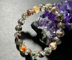 This is a high quality phantom quartz bracelet. Each bead is very unique and beautiful color ! Weight:24g Wrist Size: 15-15.5cm/6.1 inch Bead Size:9.6mm Phantom quartz is a variety of quartz consisting of visible layers of overlapping crystal growths. The outline of the inner crystals can be seen due to some variation in composition or mineral inclusion making the boundary between growths visible. The interior crystal layers are known as phantoms. Phantom or Ghost Quartz as it is often termed is Crystal Growth, Ghost Images, Phantom Quartz, Beads Bracelets, Jade Bracelet, Quartz Bracelet, Bracelet Bangle, Silver Bangles, Healing Stones