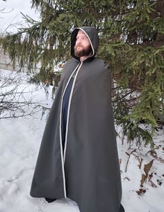 "Shop now Long medieval hooded cloak for men! Medieval hooded cloak in dark green with beautiful trim embellishment. Awesome Medieval prince' cape, viking cloak, elven hooded cape. Just perfect for LARP events, viking festivals, renfaire events etc. See more hooded cloaks here https://www.etsy.com/shop/EthnicandMedieval?ref=seller-platform-mcnav&section_id=35034993 The length (top shoulder to hem) - 59\" (150 cm).  The fabric is a lightweight polyester, really stunning colour. It has a velvet sh Elvish Hooded Cape For Costume Party, Medieval Cape For Fantasy Events, Halloween Cape For Larp Events, Elven Cape Outerwear For Costume, Hooded Cape For Fantasy Events In Winter, Halloween Cape For Larp, Capes For Men Cloaks, Halloween Cape Outerwear For Larp, Hooded Winter Cape For Fantasy Events