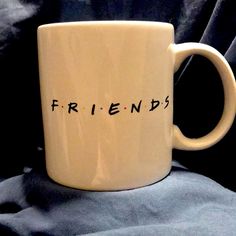 a white coffee mug with the word friends written on it