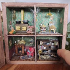 a doll house with furniture and accessories in it's display case on a wooden floor