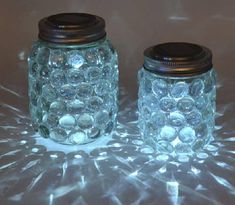 two mason jars sitting on top of a table next to each other with the words easy mason jar luminaries