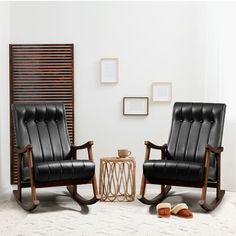 two black chairs sitting next to each other in a living room with white walls and flooring