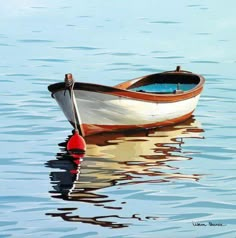 a small boat floating on top of a body of water