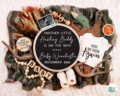 a baby announcement is displayed on a blanket with other items and things to include in it