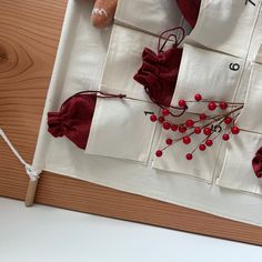 a piece of cloth with some red berries on it and a teddy bear sitting next to it