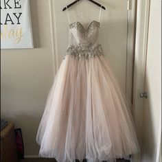 a dress hanging on a hanger in front of a door