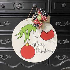 a christmas door hanger with an elf on it