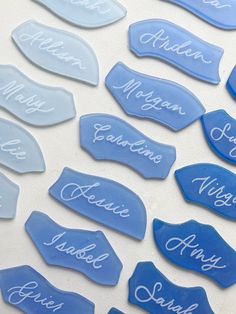 blue and white glass name tags with names on them