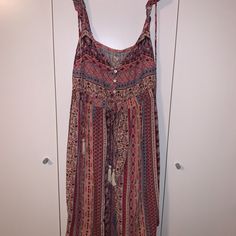 This Dress Is A Size Medium From Hollister And The Straps Are Adjustable Spaghetti Straps As Well As Straps That Go Over The Shoulder And It Has Some Waviness To The Sleeve. On The Top Front, There Are Buttons That Go Down Where The Chest Is So They Can Be Adjusted. There Are Colors Such As Blue, Pink, Burgundy, Beige, And Many More Colors That Are Designed In A Variety Of Patterns Including Some Tribal Patterns. There Is Also A Big Tie That Has Fringes At The End And It Ties In The Back. Nwt. Pink Sleeveless Maxi Dress Beach Cover-up, Bohemian Pink Sleeveless Sundress, Pink Bohemian Sleeveless Sundress, Pink Spaghetti Straps Sundress, Pink Maxi Dress With Spaghetti Straps For Beach, Pink Spaghetti Strap Midi Dress For The Beach, Pink Spaghetti Strap Midi Dress For Beach, Pink Spaghetti Strap Beachwear Dress, Pink Casual Boho Beach Dress