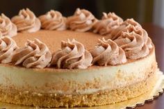 a cake with frosting sitting on top of a wooden table