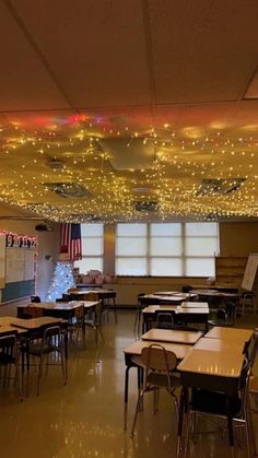 an empty classroom with lights on the ceiling