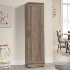 a tall wooden cabinet sitting in the middle of a living room