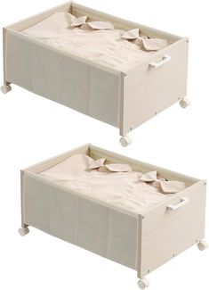 two small beds with white linens on each side and one has an open drawer