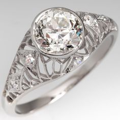 Circa 1920s domed ring features a pierced design and is centered with one (1), bezel set, old European cut diamond. The gallery is accented with six (6), bead set, round single/Swiss cut diamonds. The ring measures 9.8mm at the top, rises 7.0mm above the finger, tapering to 2.0mm wide and 1.2mm thick at the base of the shank. Antique Cocktail Ring, Diamond Ring Platinum, European Cut Diamond Ring, Antique Wedding Rings, Antique Diamond Rings, Antique Engagement, Bead Set, Antique Engagement Rings, European Cut Diamonds