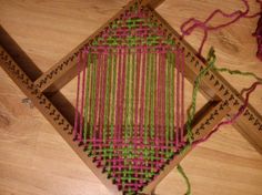 a close up of a weaving machine on a wooden floor