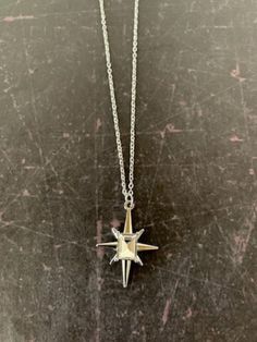 "Lovely silver tone 8 point star necklace with center emerald cut clear stone, star necklace, star necklace silver, 8 point star pendant, clear stone necklace, north star necklace, star  Pendant measures 1\" L X 7/8\" W and is on an 18\" chain.   ★ Want to see more?  Please visit my shop at: https://www.etsy.com/shop/DesignsByPeg" Silver Star Charm Necklaces, Silver Necklaces With Star Charm, Silver Star Of David Charm Jewelry, Silver Star Charm Necklace, Silver Pendant Charm Necklace With Star Charm, Silver Pendant Charm Necklaces With Star Charm, Dainty Silver Star Of David Necklace, Dainty Silver Starburst Jewelry, Silver Star-shaped Celestial Charm Necklaces