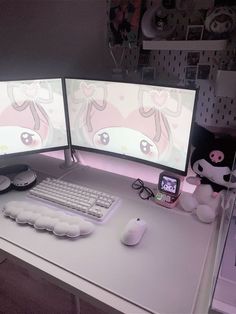 two computer monitors sitting on top of a desk next to a keyboard and monitor screen