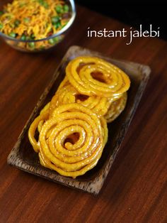 some food is sitting on a wooden plate