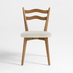 a wooden chair with a white upholstered seat and back cushion on an isolated background