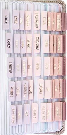 several rows of pastel pink and white books with gold foil lettering on the covers