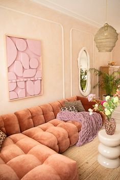 a living room filled with lots of furniture and flowers in vases on the table