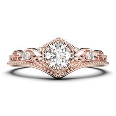 a rose gold engagement ring set with a round diamond in the center and an intricate band