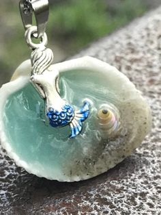 "Mermaid in a Shell Necklace, Beach Lover Gift, Mythical Fun Jewelry, Gift for her, unique necklaces for women, Gifts for Sister, Beach Wedding Handmade and unique Mermaid in a Shell necklace. Mermaid Bath This beautiful Mermaid in a shell necklace has been handmade by me using real sand a real seashell and resin. Be Unique, have an original design, This necklace will be a conversational piece. The water also glows in the dark if you leave it under a UV lamp or in the sunlight for a few minutes. Ocean-inspired Adjustable Charm Necklace Gift, Blue Charm Necklaces For The Beach, Whimsical Blue Pendant Jewelry, Personalized Blue Bohemian Necklace, Bohemian Mermaid Necklace For Gifts, Bohemian Mermaid Necklace Gift, Whimsical Blue Charm Jewelry, Whimsical Blue Jewelry With Charms, Whimsical Blue Charm Necklace As Gift