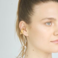 a close up of a person wearing ear clips