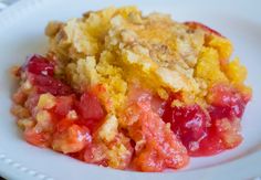 a close up of a plate of food on a table with a casserole in the background