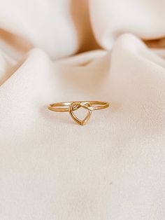 Heart Knot Ring, Love Knot Ring, Gold Infinity Heart Ring, Heart Knot Ring Gold, Gold Stacking Rings, Gold Knot Ring, Silver Knot Ring   This Ring is so lovely and gorgeous. Created from gold-filled, rose gold-filled, or sterling silver round wire, this ring features an open heart-shaped with a love-knot design and presents an attractive, dainty look. *CURRENT PRODUCTION WORKS* All items are made to order. Please check our policies page, our time to work 8-10 business days, or for the updated pr Minimalist Adjustable Heart Ring For Wedding, Delicate Adjustable Heart Promise Ring, Dainty Adjustable Open Heart Rings, Gold Infinity Ring For Valentine's Day, Adjustable Heart-shaped Stackable Promise Rings, Adjustable Open Heart Ring For Wedding, Heart-shaped Adjustable Stackable Wedding Rings, Adjustable Heart Stackable Rings For Wedding, Adjustable Heart-shaped Elegant Midi Rings