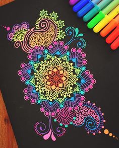 an adult coloring book with colored markers and crayons