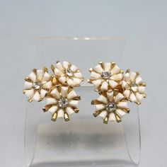 These adorable vintage 1960s era screw back earrings are made with clear rhinestones set into white plastic flower settings.  They are flower shaped  with goldtone metal clips. They measure 1 1/4 inches in diameter .  They are in excellent  condition and Signed CORO.  We will send these to you in a lovely gift box for easy gift giving or safe storage. If you like vintage costume jewelry, old silver, bolo ties and more, please check out my shop, www.etsy.com/shop/PANDPF White Retro Clip-on Earrings As Gift, Retro White Clip-on Earrings As Gift, Vintage Flower Shaped Clip-on Earrings, Vintage Flower Shaped Earrings For Anniversary, Vintage Flower-shaped Earrings For Anniversary, Retro White Flower Jewelry, Retro White Clip-on Jewelry, Vintage White Clip-on Earrings For Wedding, Vintage Flower Earrings For Wedding