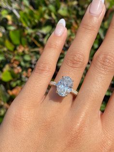 a woman's hand with a ring on it and a diamond in the middle