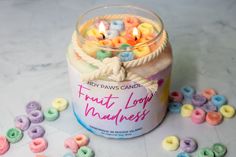 a jar filled with lots of different colored doughnuts