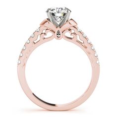 a rose gold engagement ring with an intricate design and round brilliant cut diamond center stone