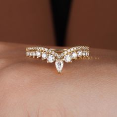 a woman's hand with a ring on her left arm and a diamond band