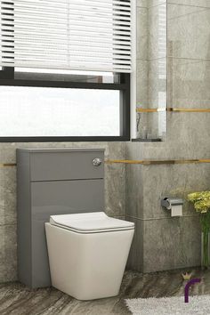 a white toilet sitting in a bathroom next to a window with blinds on the windowsill