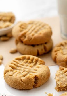 peanut butter cookies are on a table next to a glass of milk