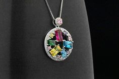 Here we have a beautiful and uniquely designed Classic Art Deco Style circle multi-gemstone pendant. The pendant features the following simulated gemstones: red ruby, blue topaz, green emerald, yellow citrine, pink sapphire and simulated round-cut diamond stones. The total carat weight is about 3.25 cts. The pendant will come with a box chain. Please choose the length of chain (16-in or 18-in). This pendant is also finished in Platinum overlay for the shine & luster of a platinum made jewelr Multicolor Round Gemstones With Stone Setting, Elegant Multicolor Gemstone Pendant, Elegant Multicolor Pendant Gemstones, Multicolor Jewels Sterling Silver Jewelry, Fine Jewelry Multicolor Stone Setting, Multicolor Cubic Zirconia Birthstone Jewelry, Multicolor Round Pendant Jewelry With Stones, Multicolor Jeweled Sterling Silver Jewelry, Multicolor Stone Round Pendant Jewelry