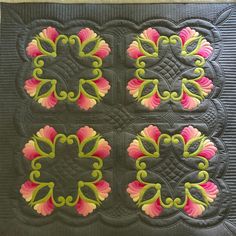 a close up of a quilt with flowers on it