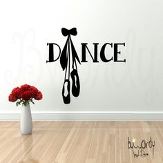 a wall decal that says dance with scissors and roses in a vase on the floor