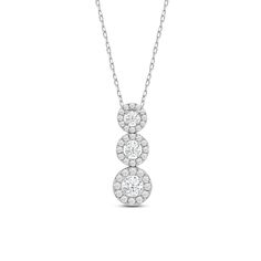 Layer your outfit with just the right amount of brilliance through this three-stone necklace. This beauty features a vertical pendant composed of three concentric rings in graduating sizes. On each ring is a diamond in a faceted bezel surrounded by a circular frame of more round diamonds. Three Stone Round Diamond Necklace, Three Stone Cubic Zirconia Fine Jewelry Necklaces, Diamond White Three Stone Diamond Necklace, Formal Three Stone Cubic Zirconia Necklace, Diamond White Three Stone Round Necklace, Formal Cubic Zirconia Three Stone Necklace, Three Stone Cubic Zirconia Diamond Necklace, Formal Three Stone Round Diamond Necklace, Diamond White Three Stone Necklace For Formal Occasions