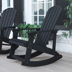 two black rocking chairs sitting next to each other