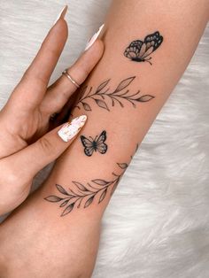 a woman's arm with butterflies on it