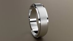 a white gold wedding ring on a grey background